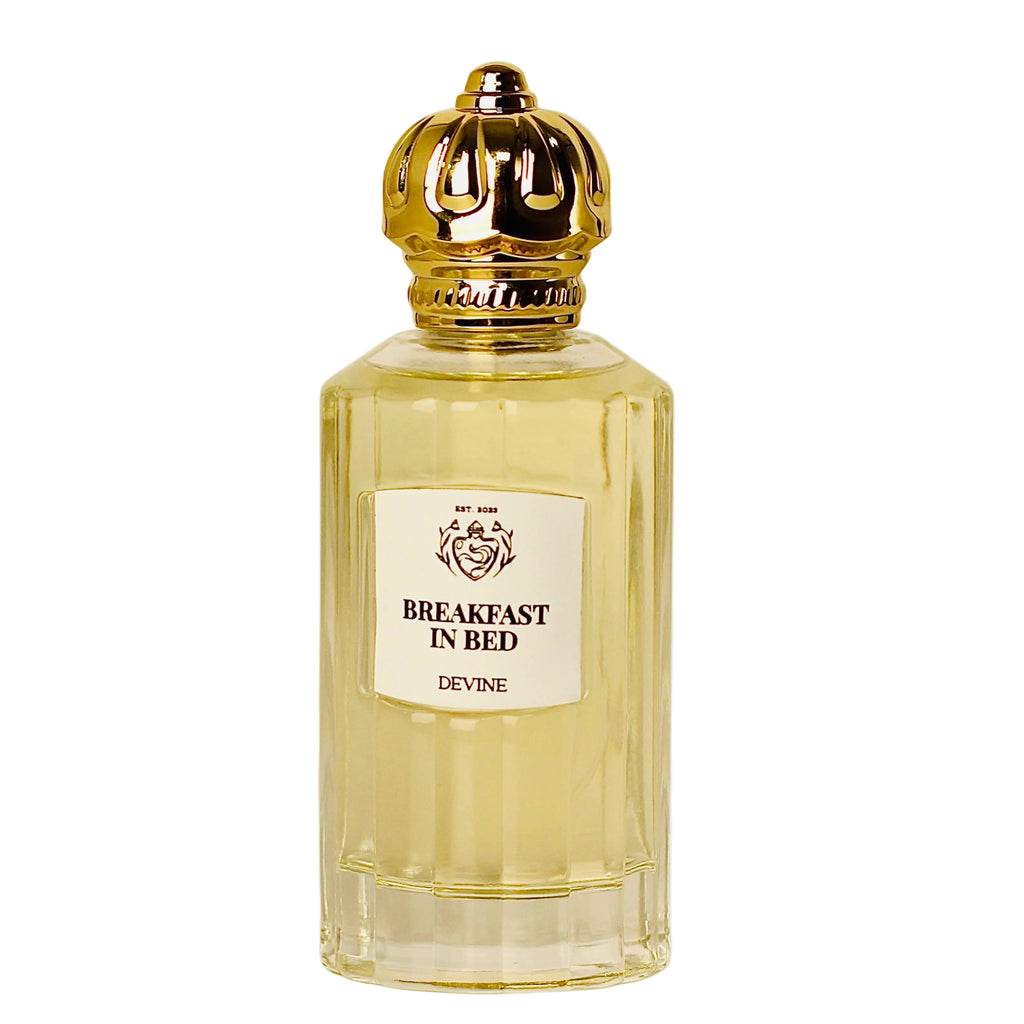 Perfume bottle labeled 'Breakfast in Bed' by Devine on a white background