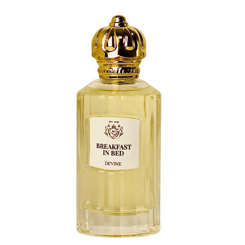 Perfume bottle labeled 'Breakfast in Bed' by Devine on a white background